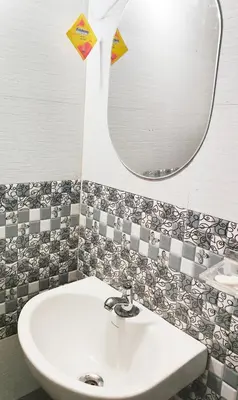 a bathroom with a sink and a mirror at Sintra Villa in Meppādi