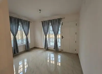 an empty room with two windows and a door at Sintra Villa in Meppādi