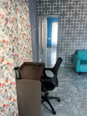 an office with a desk and a chair in a room at Chamundi Temple-Hill View in Mysore
