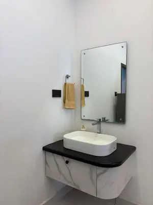 a bathroom with a sink and a mirror at Serene riverside retreat in Kozhikode