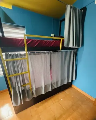 a room with two bunk beds in a room at Avenue Dorms in Kalpetta