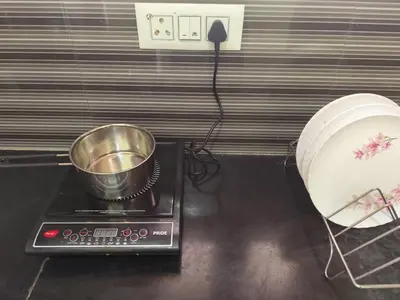 a pot on top of a stove in a kitchen at My Sooru - Spacious 2BHK Homely Retreat in Mysore
