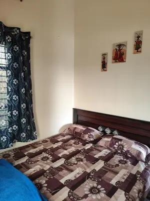 a bedroom with a bed with a quilt on it at My Sooru - Spacious 2BHK Homely Retreat in Mysore