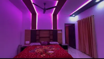 a bedroom with a bed with purple lighting at Bougain Villa Hilltreat in Muthalamada