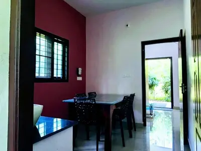 a kitchen with a table and chairs in a room at Forest edge Villa - 3 bedrooms in Ambalavayal