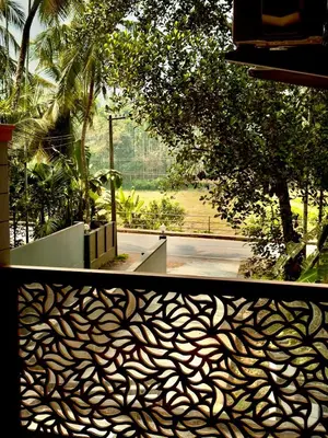 a view of a park with a fence and trees at Sawan Home stay - 2 BHK fully furnished in Kozhikode