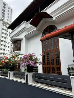 a building with potted plants on a balcony at Metro Bliz in Alwaye