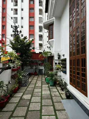 a courtyard of a building with potted plants and buildings at Metro Bliz in Alwaye