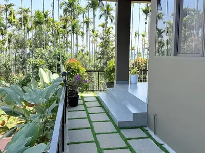 a patio with plants and flowers in a house at Valensa lake view in Kalpetta