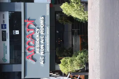 a sign for a store in front of a building at Amani Residency Kannur in Kannur