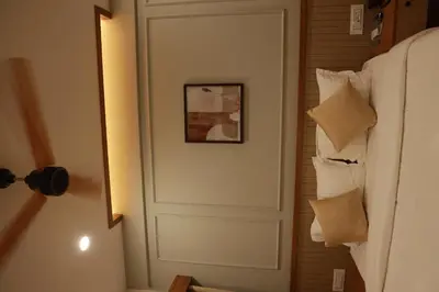 a door in a room with a picture on the wall at Amani Residency Kannur in Kannur