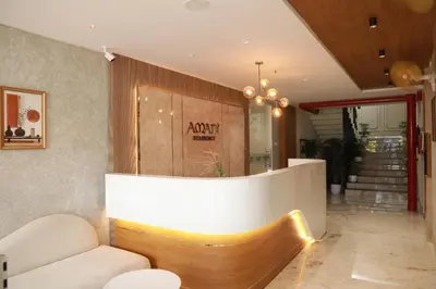 a lobby with a couch and a reception desk at Amani Residency Kannur in Kannur