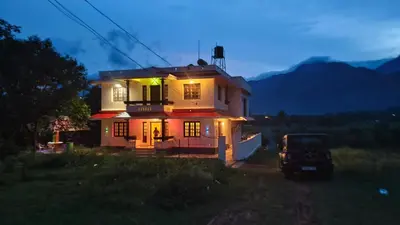 a house with a car parked in front of it at Dew drops Marayoor in Kanthalloor