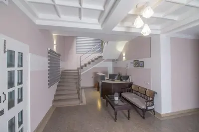 a living room with a staircase and a couch at Mounts shelts in Munnar