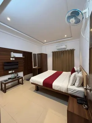 a bedroom with a bed and a television in it at Hemara suites