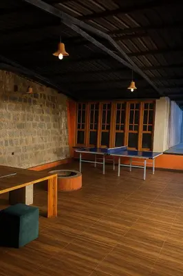 a room with benches and tables in a building at Secret Escape Heritage Bungalow in Ooty