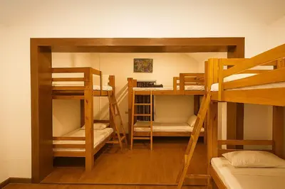 a room with three bunk beds in a room at Secret Escape Heritage Bungalow in Ooty