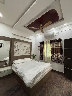 a bedroom with a bed and a ceiling fan at Arranyaa retreatt- Girrafe's gallery in Mysore
