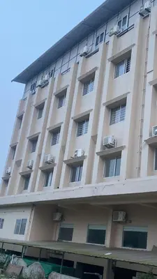 a large building with windows and air conditioning at Nova Alhind Airport Hotel in Nedumbassery