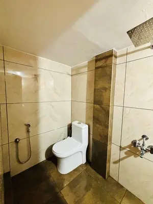 a bathroom with a toilet and a shower at Neelees Retreat in Kaniyāmbetta