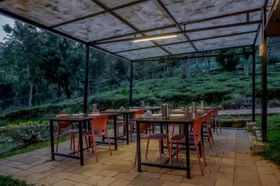 a patio with tables and chairs under a pergola at Silver Heaven, Kotagiri in Kotagiri