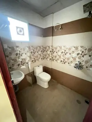 a bathroom with a toilet and a sink at Le Divine C3 Premium 1bhk Apartment 100meters from Guruwayur temple in Guruvāyūr