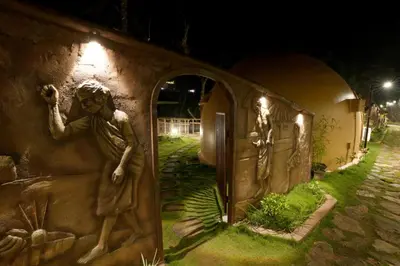 a statue on the side of a building at night at Lake Lagoon Moonhills in Mennānyam