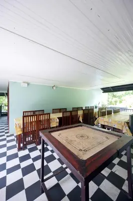 a room with a ping pong table on a checkered floor at Snow Drops Resort in Vythiri