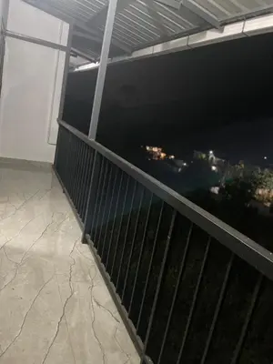 a balcony with a view of a city at Mountholidays in Meppādi