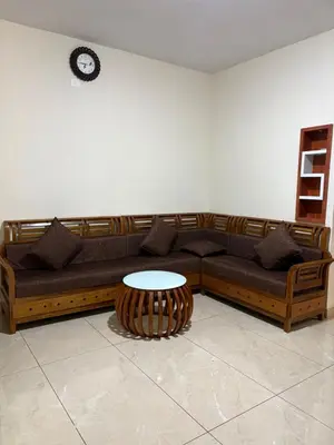 a living room with a couch and a table at ARAMAM SERVICE VIlla in Mananthavady