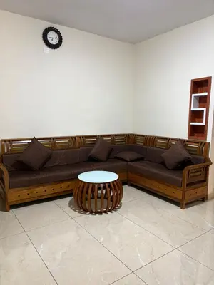 a living room with a couch and a table at ARAMAM SERVICE VIlla in Mananthavady