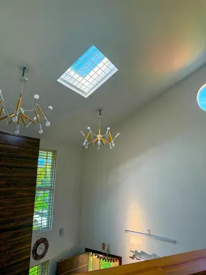 a living room with a ceiling with a chandelier at White House, Managed By Triora Escapes in Maddūr