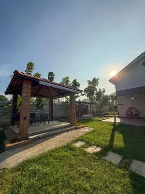 a pavilion in a yard next to a building at White House, Managed By Triora Escapes in Maddūr