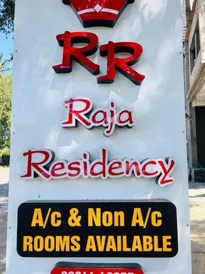a sign for a raya restaurant on the side of a building at Raja Residency Near isha Foundation Adiyogi in Coimbatore