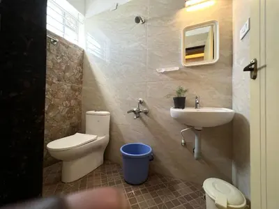a bathroom with a toilet and a sink at Raja Residency Near isha Foundation Adiyogi in Coimbatore