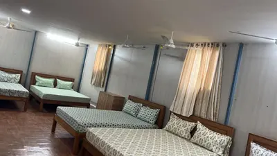 a room with two beds and a couch at Raja Residency Near isha Foundation Adiyogi in Coimbatore