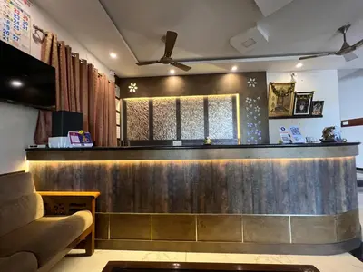 a bar at a restaurant with a couch at Raja Residency Near isha Foundation Adiyogi in Coimbatore