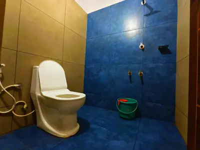 a bathroom with a toilet and a shower at z in wayanad in Kalpetta