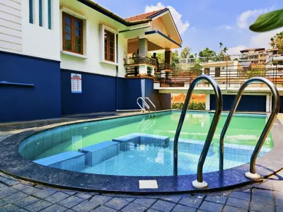 a swimming pool in a house with a swimming poolvisorvisorvisor at z in wayanad in Kalpetta