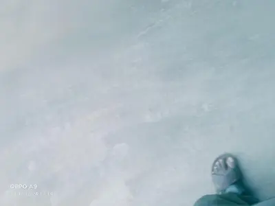 a person riding a snowboard down a snow covered slope at Nalukettu Veedu in Thottada