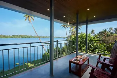 a balcony with a view of the ocean at Akanta Cherai Beach Resort in Cochin