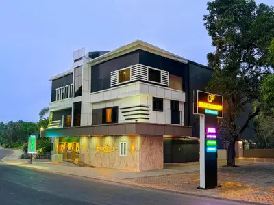 a building on the side of a street with a sign at PANCHAVADY RESIDENCy in Kodungallūr