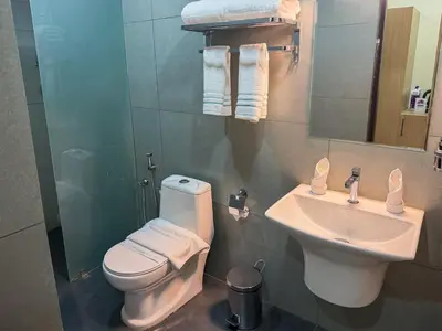a bathroom with a toilet and a sink at PANCHAVADY RESIDENCy in Kodungallūr