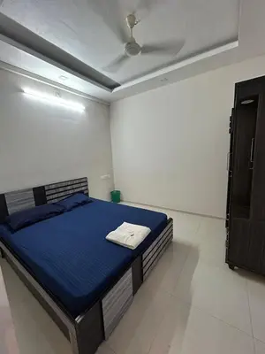 a bedroom with a blue bed in a room at Thirteen in Guruvāyūr
