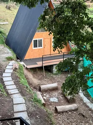 a house with a gambrel roof and a stone path leading to it at AURA Resort kookal kodaikanal in Kūkkāl