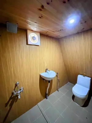 a bathroom with a toilet and a sink at AURA Resort kookal kodaikanal in Kūkkāl
