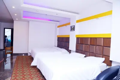 a bedroom with two beds and a red carpet at Celestial Resorts in Kotagiri