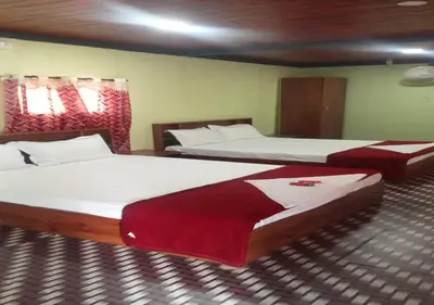 two beds in a room with two beds sidx sidx sidx sidx at Kuruva Heritage Home in Wayanad