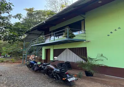 a group of motorcycles parked in front of a building at Kuruva Heritage Home in Wayanad
