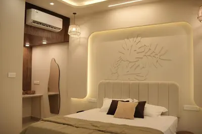 a bedroom with a bed with a large headboard at The Soul by VDN A Santorini inspired Villa in Trichūr